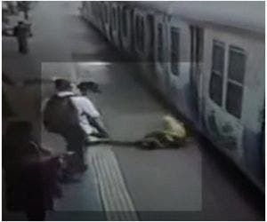 Mulher é salva segundos antes de ser arrastada por trem